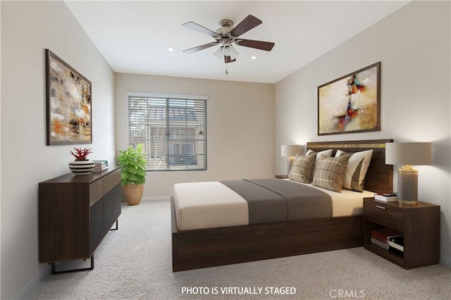 bedroom featuring ceiling fan and light carpet