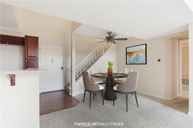 unfurnished dining area featuring ceiling fan and carpet flooring