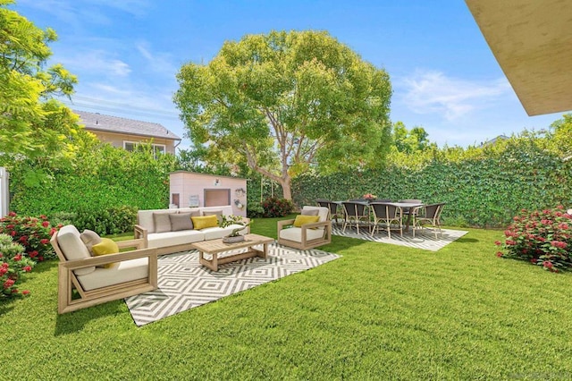 view of yard with an outbuilding, an outdoor hangout area, and a patio area