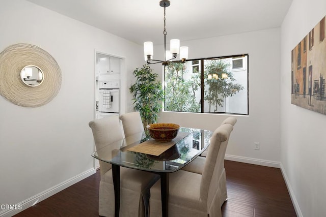 dining area with an inviting chandelier and dark wood-type flooring