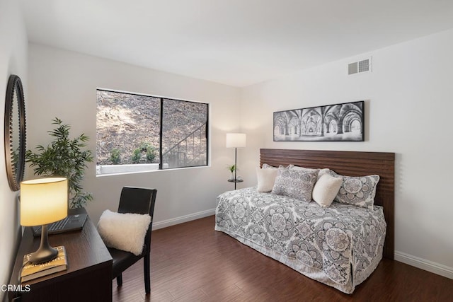 bedroom with dark wood-type flooring