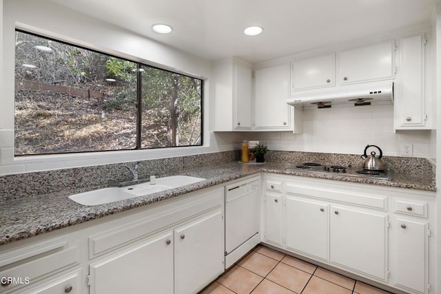 kitchen with white dishwasher, sink, and white cabinets