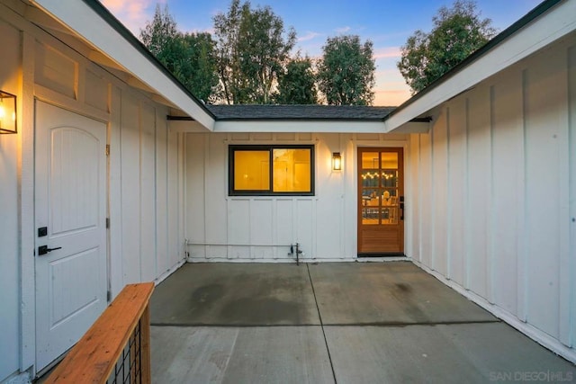 exterior entry at dusk with a patio area