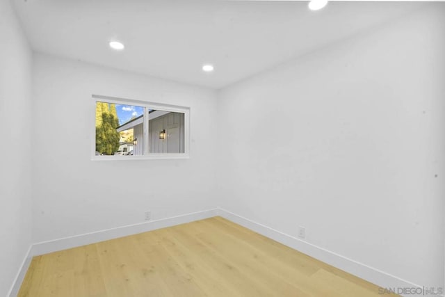 unfurnished room with wood-type flooring