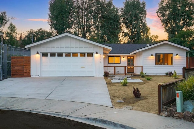 ranch-style home with a garage and a yard