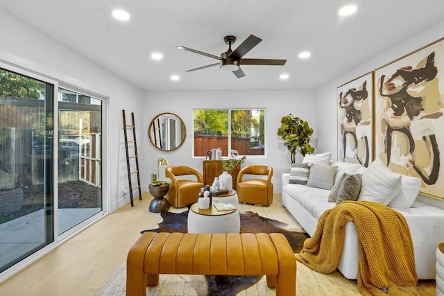 living room featuring ceiling fan and light hardwood / wood-style flooring