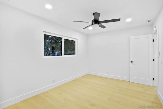 spare room featuring wood-type flooring and ceiling fan