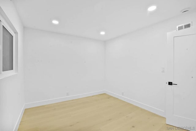 unfurnished room with hardwood / wood-style floors