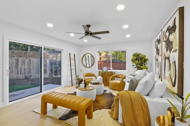 living room with light wood-type flooring and ceiling fan