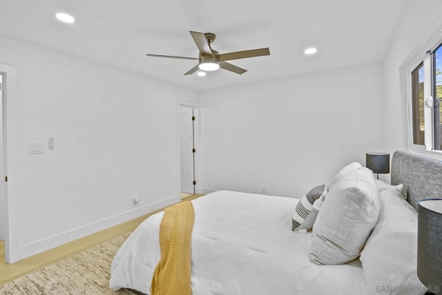 bedroom with hardwood / wood-style floors and ceiling fan