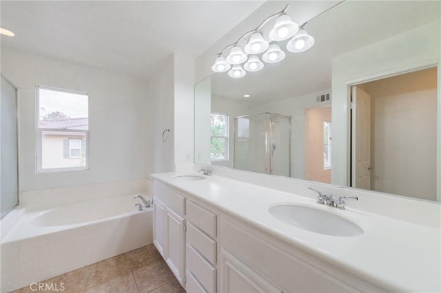 bathroom with tile patterned flooring, vanity, and separate shower and tub