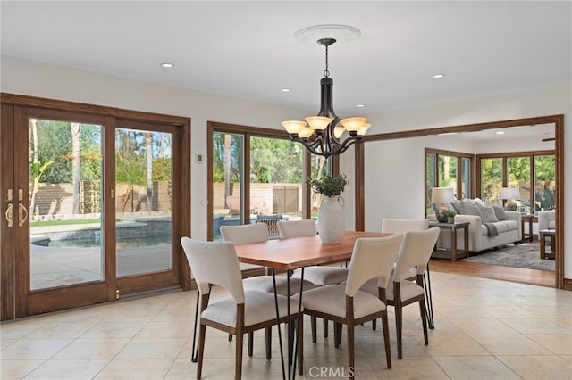 dining area with a wealth of natural light, a chandelier, and light tile patterned flooring