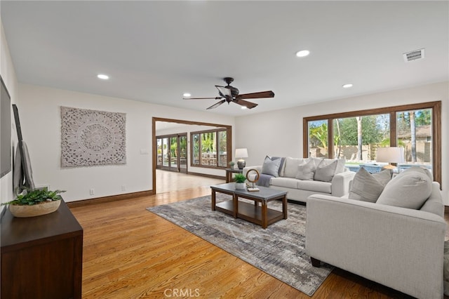 living room featuring ceiling fan and light wood-type flooring