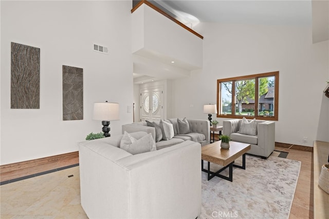 living room with high vaulted ceiling