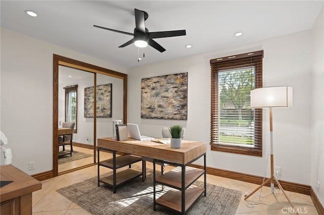 tiled office featuring ceiling fan