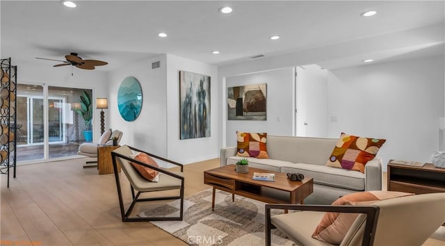 living room with ceiling fan and light hardwood / wood-style floors