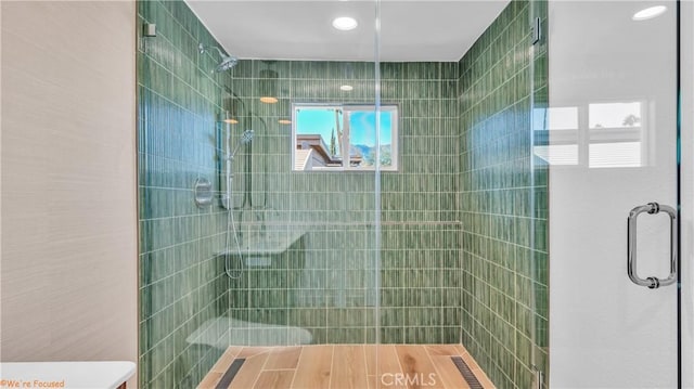 bathroom with a shower with door