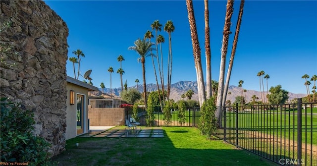 view of yard with fence and a mountain view