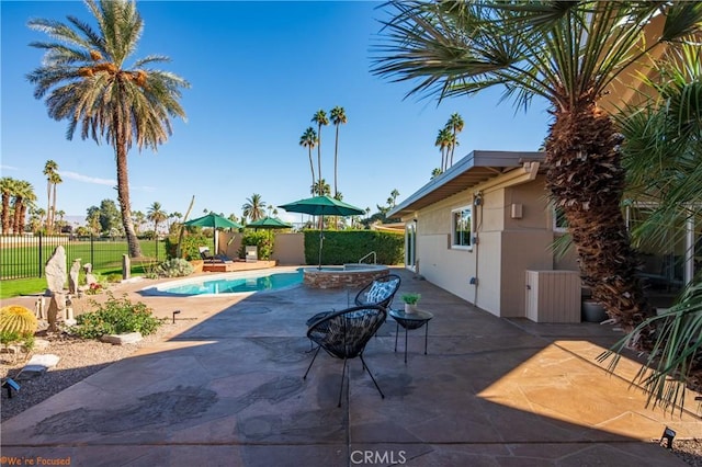 view of pool featuring an in ground hot tub and a patio