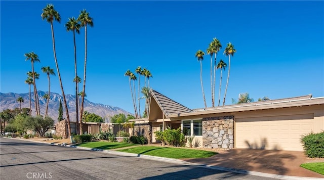 view of front of home featuring a mountain view and a garage