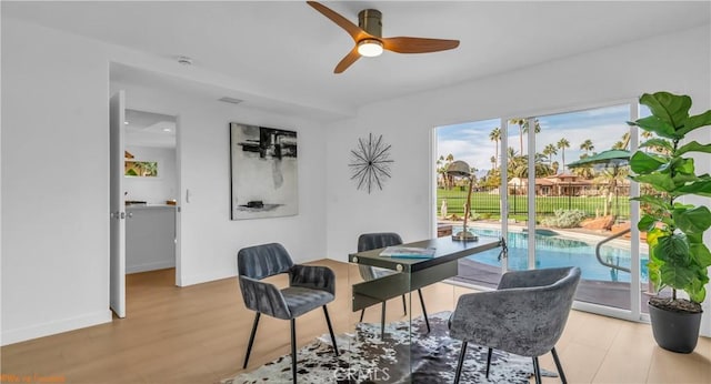 office space with ceiling fan and light wood-type flooring