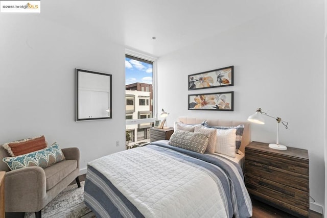 bedroom featuring floor to ceiling windows and hardwood / wood-style floors