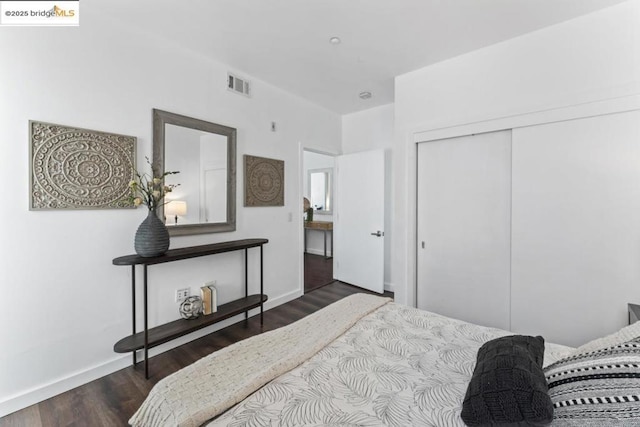 bedroom featuring dark hardwood / wood-style flooring and a closet