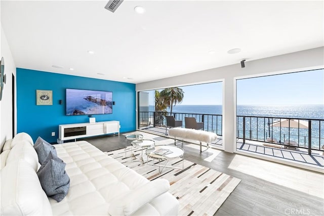 living room featuring recessed lighting, wood finished floors, and visible vents