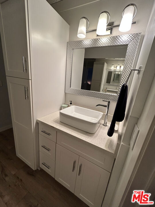 bathroom with vanity and hardwood / wood-style flooring