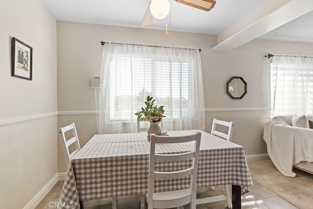 tiled dining area with ceiling fan