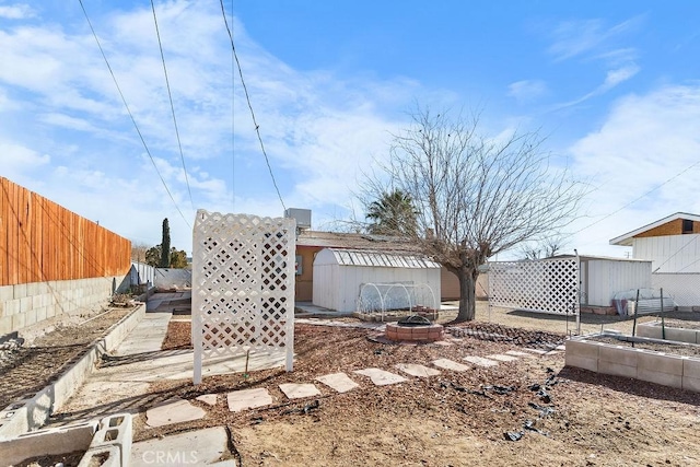 view of yard with a fire pit