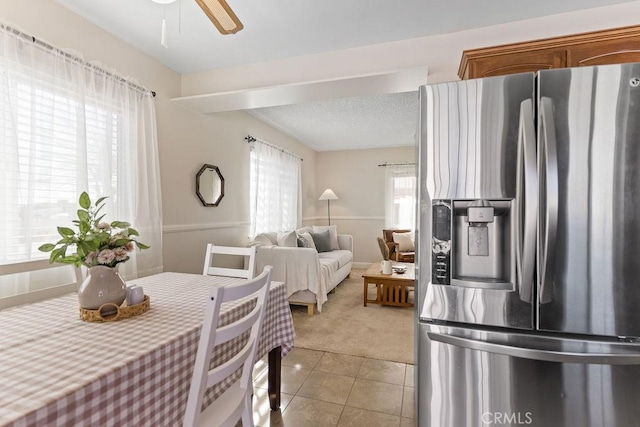 interior space featuring light tile patterned flooring and ceiling fan