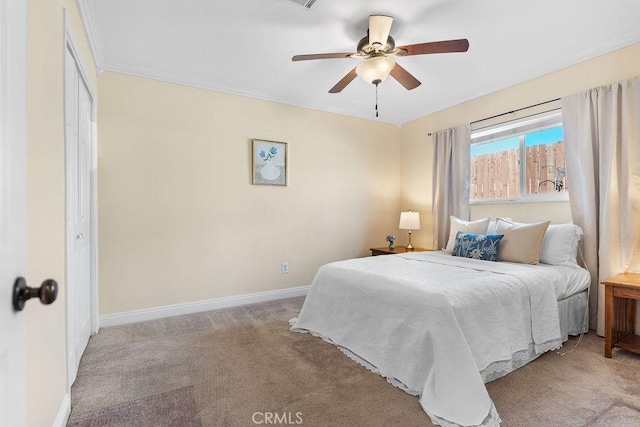 bedroom featuring ornamental molding, light colored carpet, and ceiling fan