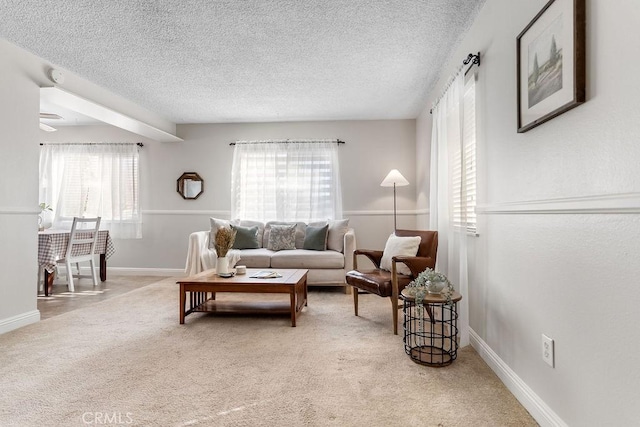 living room with light carpet and a textured ceiling