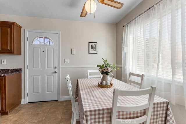 tiled dining area with ceiling fan