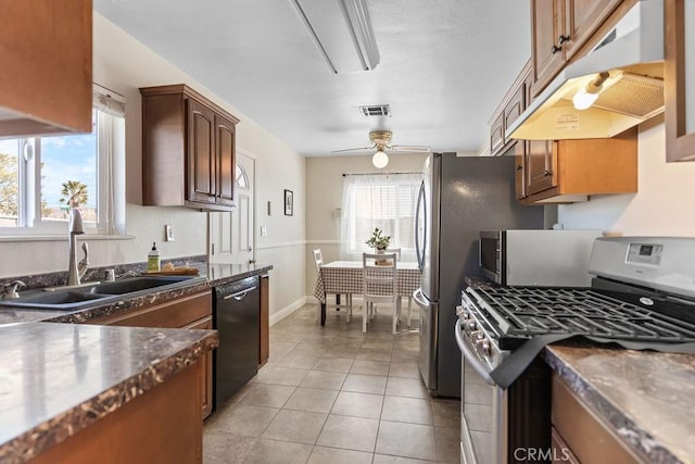 kitchen with sink, light tile patterned floors, ceiling fan, and appliances with stainless steel finishes