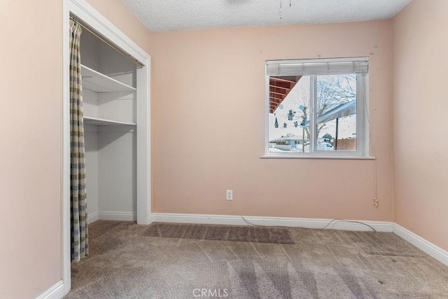 unfurnished bedroom featuring carpet and a textured ceiling