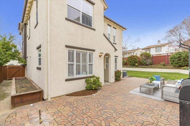 rear view of house with a patio and outdoor lounge area