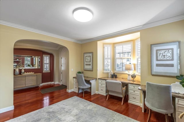 home office featuring ornamental molding, dark wood-type flooring, and built in desk