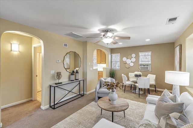 carpeted living room with cooling unit and ceiling fan