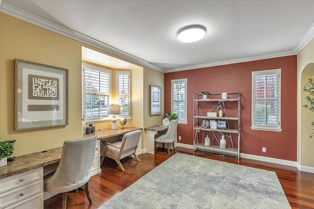 office space with built in desk, ornamental molding, and dark hardwood / wood-style floors