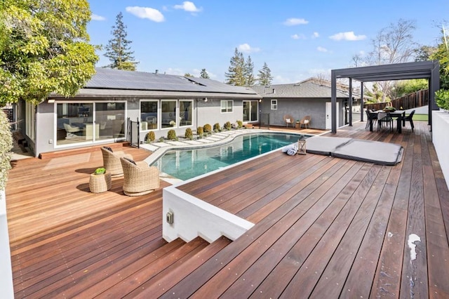 view of swimming pool with a deck and a pergola