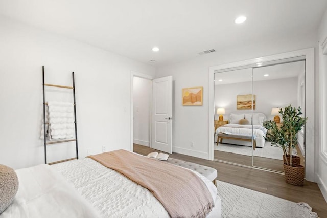 bedroom with hardwood / wood-style flooring and a closet