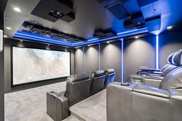 carpeted cinema with a tray ceiling