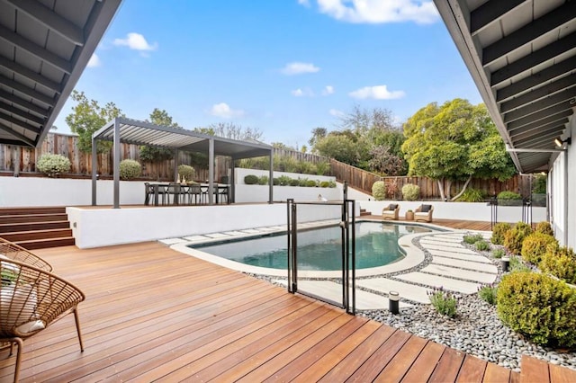 view of swimming pool featuring a wooden deck, a pergola, and a patio