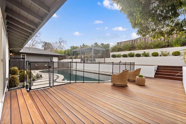 wooden deck featuring a fenced in pool and a patio area