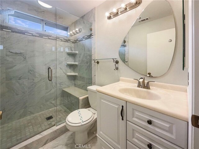 bathroom featuring an enclosed shower, vanity, and toilet