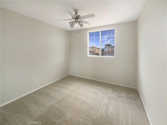 carpeted empty room with ceiling fan