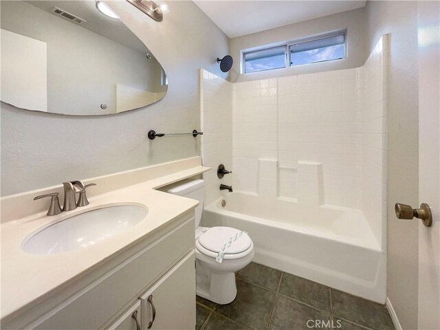 full bathroom featuring tile patterned flooring, bathing tub / shower combination, vanity, and toilet