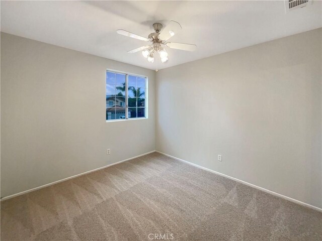 spare room with carpet floors and ceiling fan